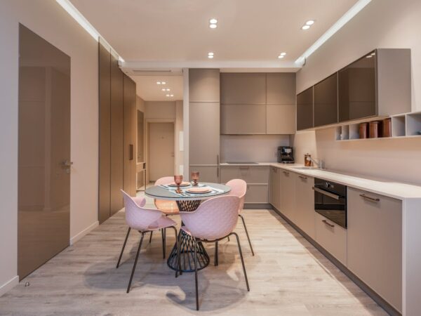 A Dining Table and Chairs Near the Kitchen Cabinets